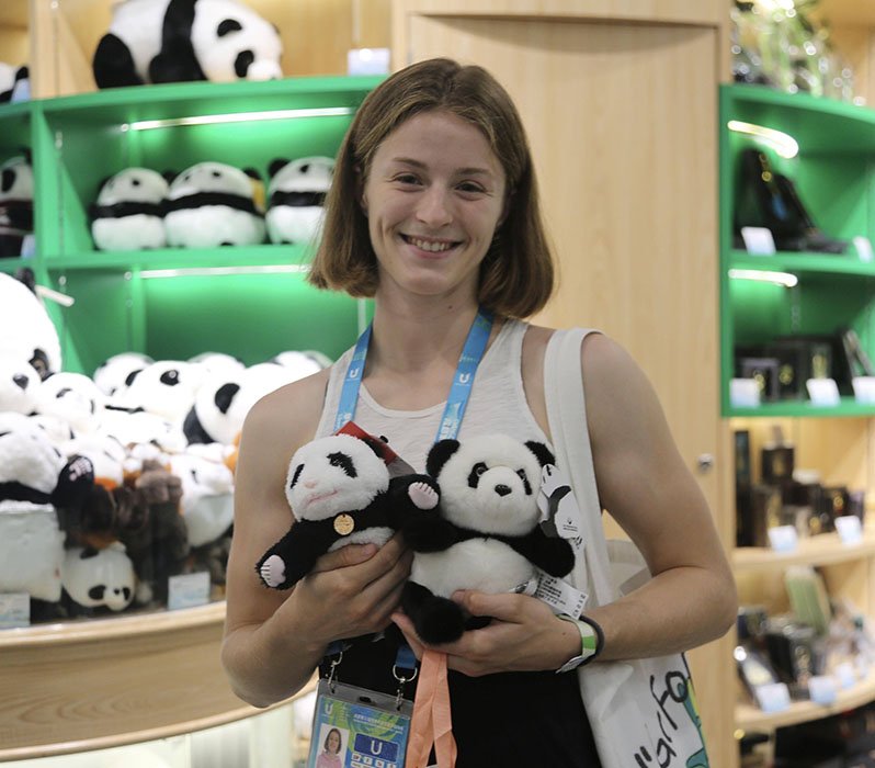 international tourists holding panda plush toys